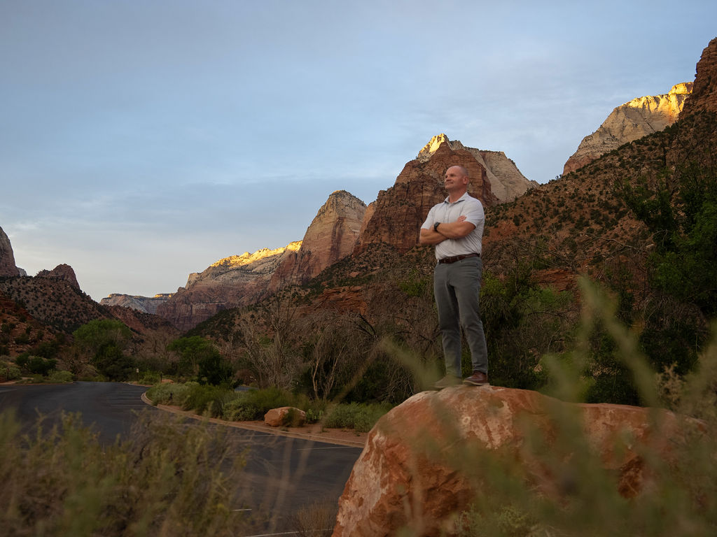Brandon Olson standing on a ridge above the St. George valley, looking ahead